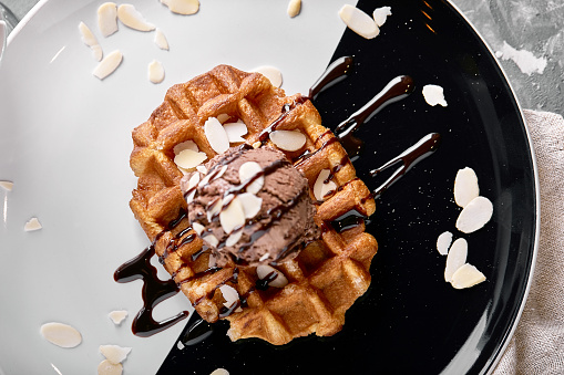 Viennese waffles with ice cream, chocolate. Close-up. On the plate.