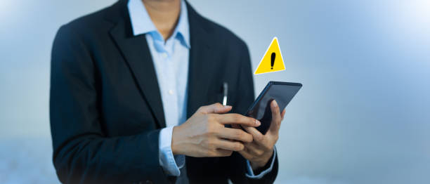 istock businessmen,working online, have warnings to protect against,cyber-attacks, tracking hacking events that cause phone crashes. 1934877246