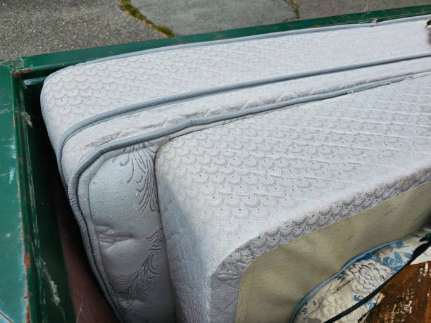Old Mattress and Box Spring An old mattress and box spring seen sitting in the corner of a dumpster. overflowing trash dumpster stock pictures, royalty-free photos & images