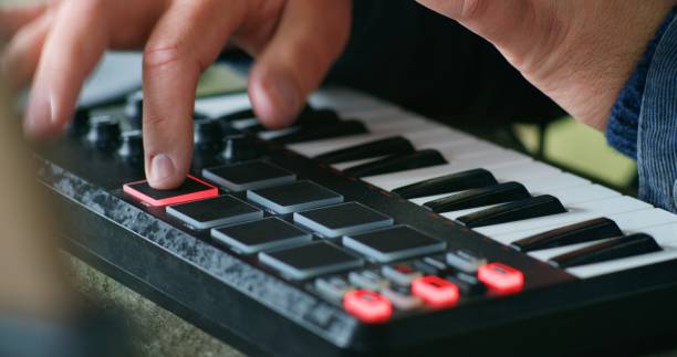 istock Male musician playing MIDI keyboard and moving rhythmically 1934905702