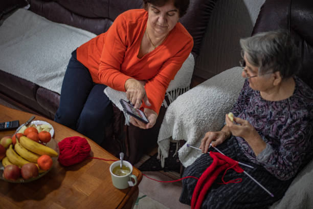 knitting, elderly woman - knitting residential structure glasses hot drink ストックフォトと画像