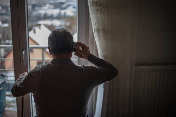 istock An elderly man is alone at home, using a smartphone 1934911800