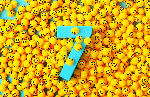 Blue number 7 surrounded by Yellow spheres textured with happy face emoji on blue background. Horizontal composition.