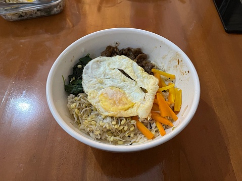 Korean signature dish named Bibimbap which is rice mixed with many kinds of vegetable, beef and sauce