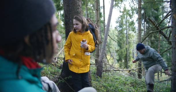 istock Multiethnic young hikers talking, having snack in the forest during trek 1934924544