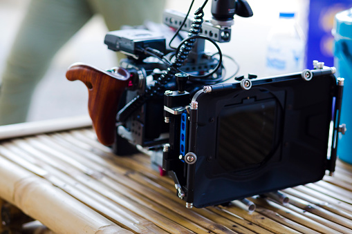 Close-up of video camera equipment on bamboo table