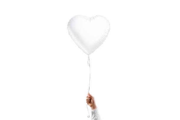 istock Hand holding blank white heart balloon mockup, isolated 1934941702