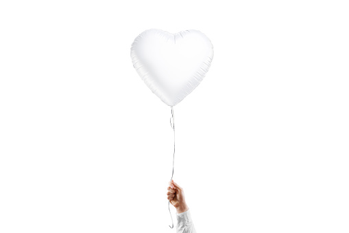Hand holding blank white heart balloon mockup, isolated, 3d rendering. Empty helium love decorative ball for valentine or wedding mock up, front view. Clear inflatable latex mylar ballon template.