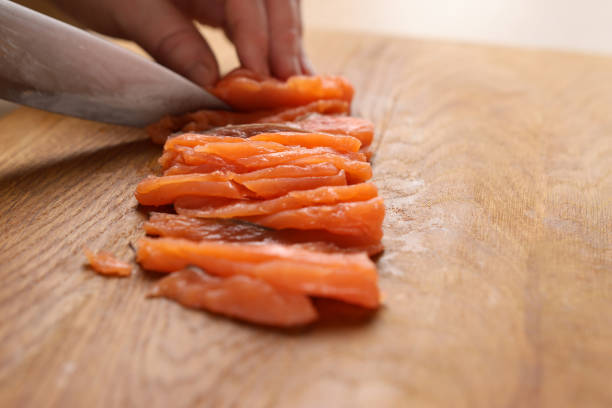 Cut the salmon into pieces with a knife. Cooking dishes from red fish