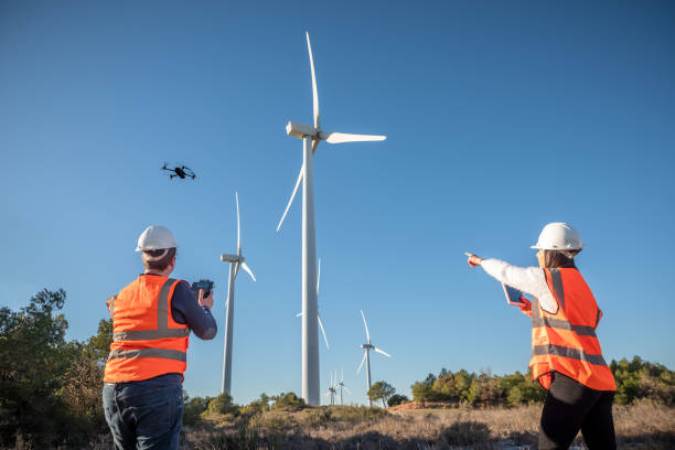 istock Engineer mechanic using drone for inspection in a windmill farm park 1934957079