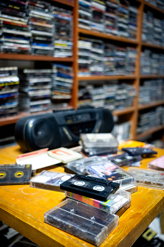 Cassette player tape recorder and a room full of old nostalgic music cassettes