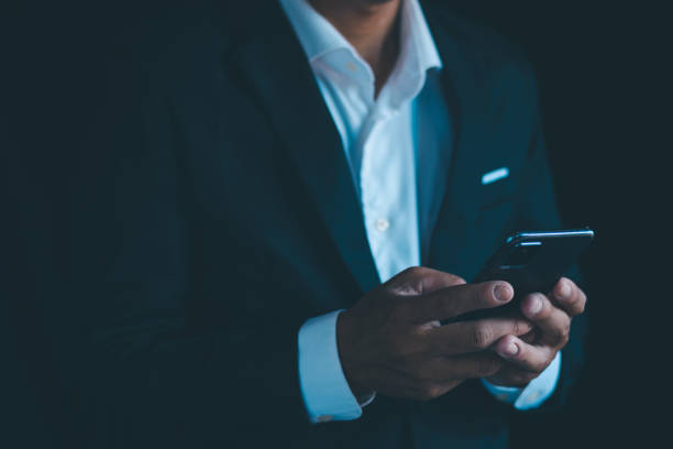 istock Businessman working on smartphone screen with free space to enter text for use. 1934988827