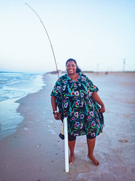 A woman enjoying a day fishing at the beach