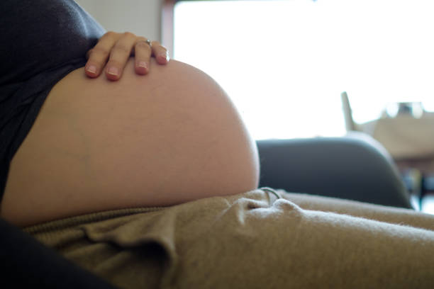 Pregnant woman resting on sofa