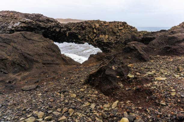 Volcanic rock arch natural in Arnardrangur Dyrhólaey nature reserve in Iceland stock photo