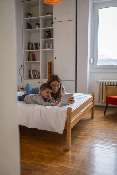 istock Mother and son watching educational videos 1934994751