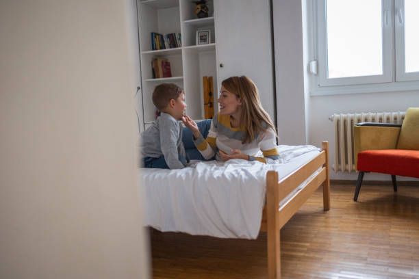 istock Mother and son sitting on the bed and talking 1934997270