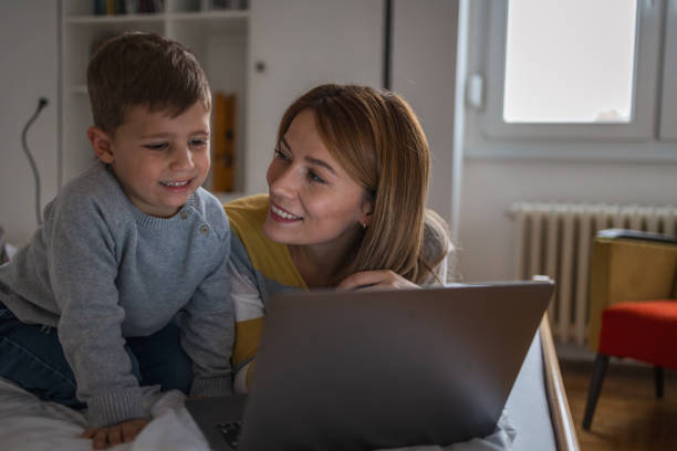 istock Close up picture of mother and son using computer 1935002548