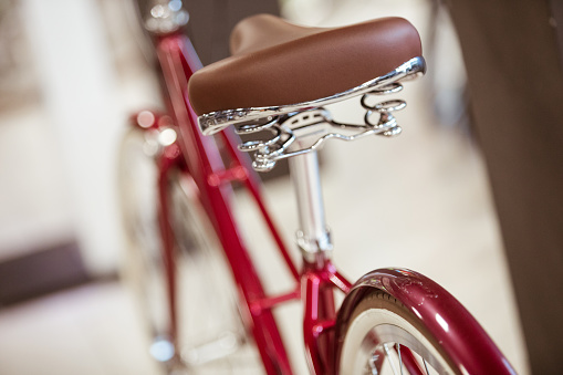 Red bike and close up of bicycle saddle.