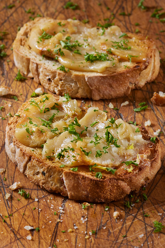 Garlic Confit Roasted in Olive Oil Spread on Toasted French Bread