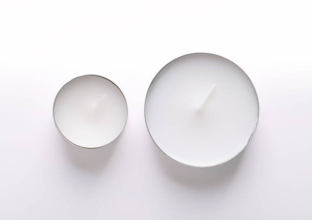 Common tealight and a maxi tealight, from above. Two types of tea lights, also called tea candle or t-lite, with different burning time, and a thin metal cup, so wax can liquefy completely while lit.