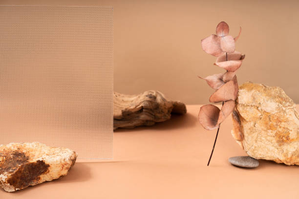 istock Patterns of natural handmade soap in different sizes and colors. Peach background made of natural materials, wood, stone, glass, dried flowers. Cosmetic natural pedestal for product promotion. 1935055688