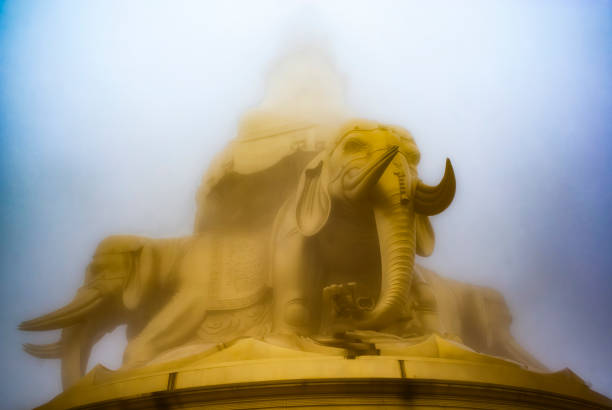 статуя бодхисаттвы пу сяня в тумане на вершине эмэйшаня, сычуань, китай, азия - emeishan стоковые фото и изображения