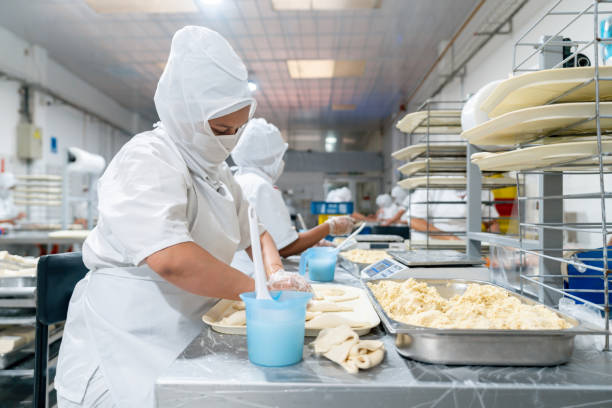 istock Employee working at an indsutrial bakery making pastries 1935070358