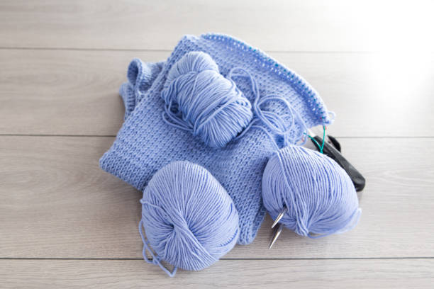 istock Set for hand knitting, blue yarn, knitting needles. 1935103802