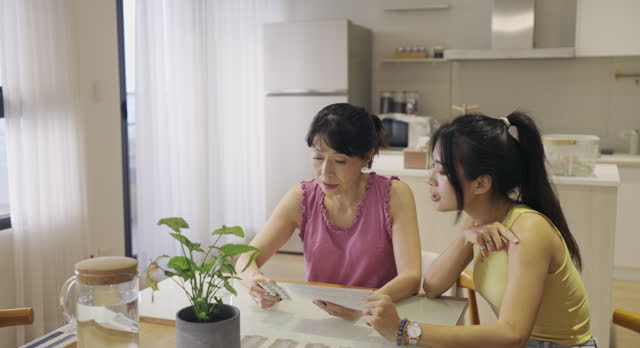 A mother and daughter discuss matters related to household expenses