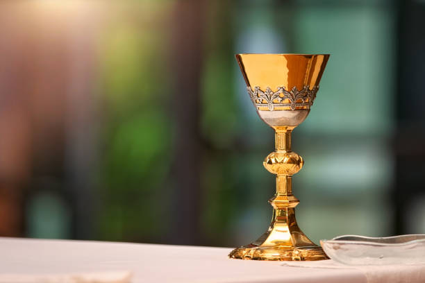 istock Chalice on the altar in church and empty space for text 1935113576