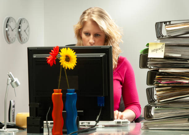 istock Young woman in office working late 1935152347
