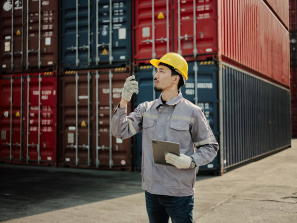 istock Asian worker wearing safety helmet and using walkie talkie 1935169871