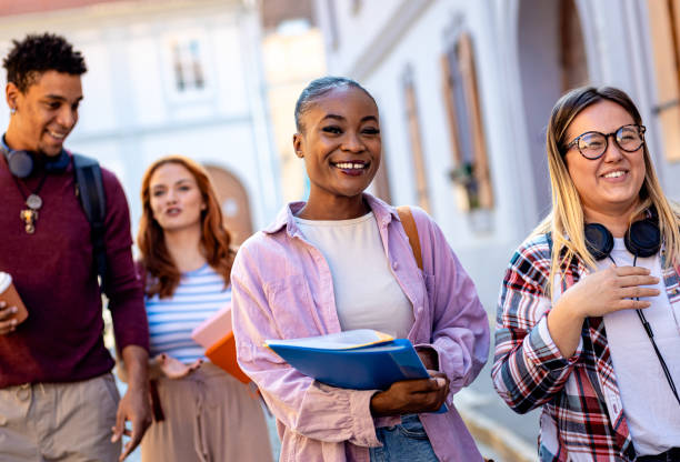 istock Diverse group of students is walking down the street. 1935177970