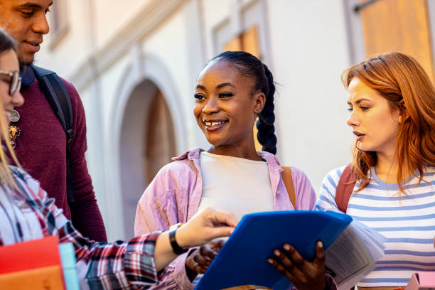 istock Diverse group of students is walking down the street. 1935178001