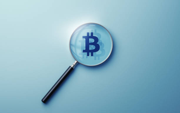 istock Bitcoin Sign Icon selected with metallic magnifying glass on soft blue background 1935180823