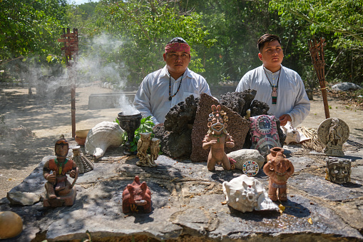 A Mayan shaman and his assistant prepare to perform a temazcal ritual in the traditional village of Dos Palmas, in the Mexican state of Quintana Roo.