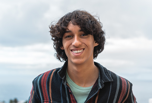Portrait of happy young teenager smiling in front of camera