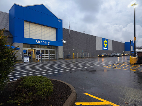 New Hartford, New York - Nov 22, 2023: Rainy Evening View of Walmart Supercenter Building Exterior.