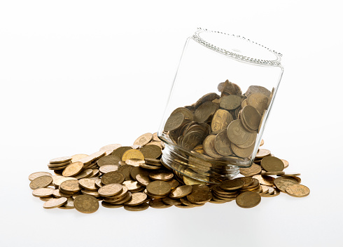 Golden coins pouring from grass jar