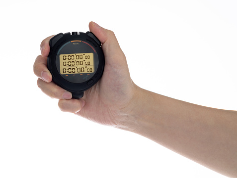 Human hand holding a digital stopwatch