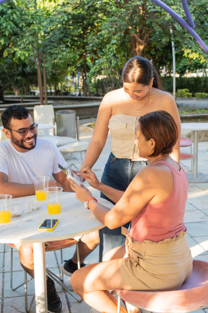 istock Friends Making a Payment in Park 1935200554