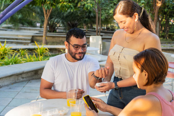 istock Latin Making a Card Payment Outdoors 1935202132