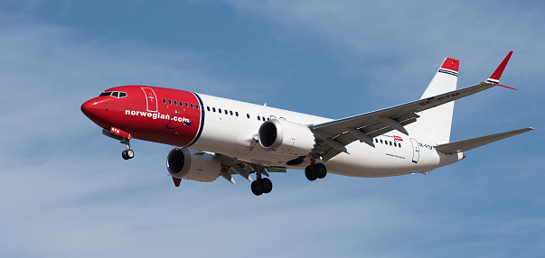 Tenerife, Spain January 13 st, 2024. Boeing 737 MAX 8 Norwegian Airlines flies in the blue sky. Landing at Tenerife Airport