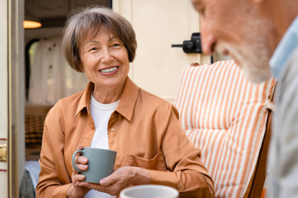 istock Happy couple having conversation, breakfast in camper van trailer 1935214282