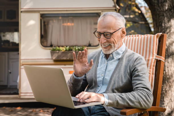 istock Old senior elderly man grandfather using laptop for remote work, having videocall 1935254904