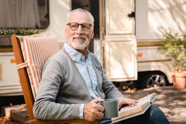 istock Closeup explorer relaxing in a chair reading book while traveling 1935263309