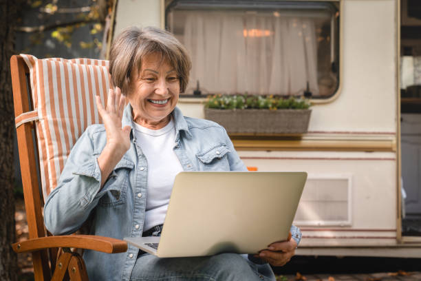 istock Happy freelancer grandmother talking on videocall webinar 1935272986