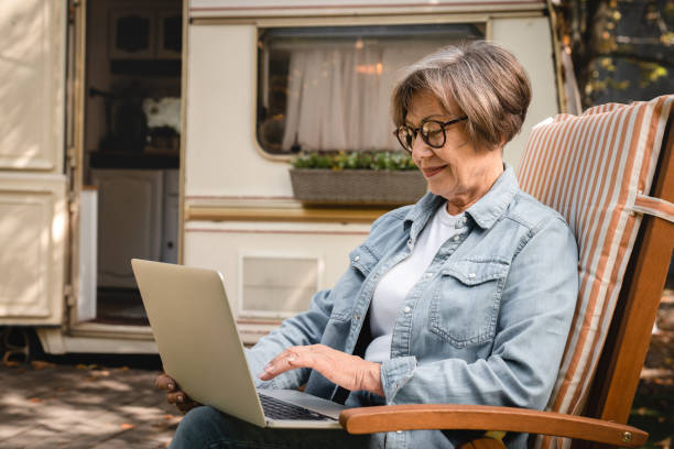 istock Old grandmother using laptop online remotely for shopping 1935272993