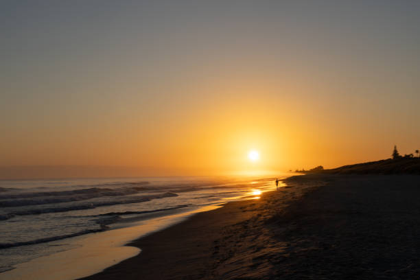 istock Blurred effect in golden glow of beach sunrise 1935281465